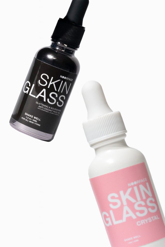 floating bottles of face oil beauty products by skinglass 